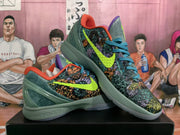 Angled view of the Nike Zoom sneaker pair displaying the multicolor illustrated panels, neon green Swoosh, orange collars, and purple accents.