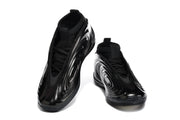 Pair of black low-top sneakers shown from the front and side