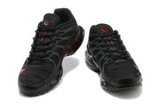 Front view of a pair of black Nike Air Max Terrascape Plus sneakers with red accents.