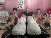 Front view of a pair of white Nike basketball sneakers with textured uppers