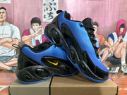 Angled side view of the blue and black sneakers displaying the layered black sole and textured blue upper.