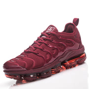 Angled view of a single burgundy Nike sneaker with lace-up closure and translucent sole.