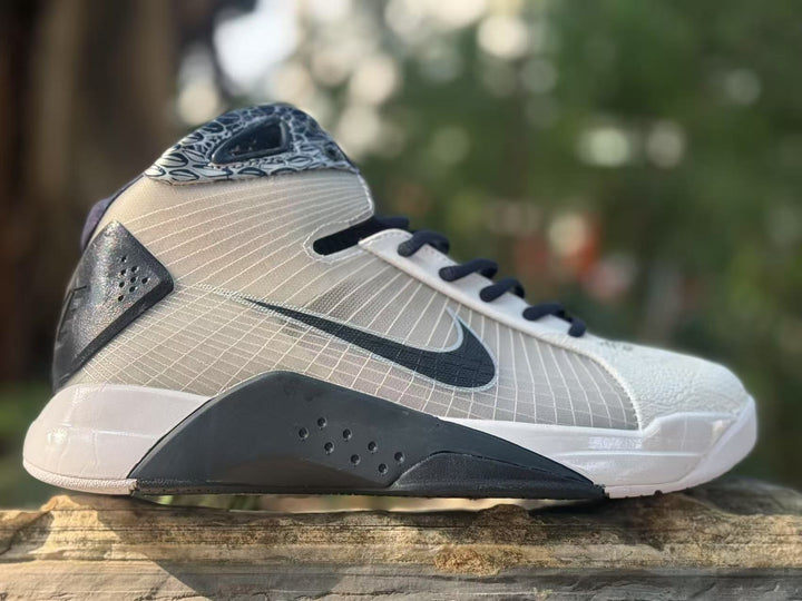 Side view of gray and black Nike HD2008 high-top sneakers with a dark Swoosh and patterned collar.