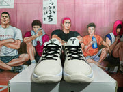 Front view of the Nike basketball sneakers showing black laces, textured white uppers, and black tongue logos.