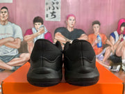 Rear view of black Nike sneakers showing the padded collars, heel panels and outsole edges.