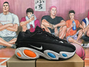 Side view of a black Nike sneaker with a visible Swoosh, white speckled midsole, and orange and blue oval accents.