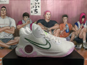 Side view of a white Nike KD basketball sneaker with green branding, purple cushioning accents, and a textured upper.