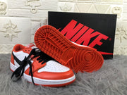 Sneaker shown with its orange patterned rubber outsole facing upward.