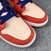 Close-up of the cream perforated toe panels, orange-pink overlays and blue laces.