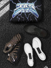 Nike sneakers, outsole, and white cushioning components arranged in front of a branded box.