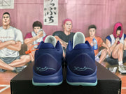 Rear view of the navy sneakers showing textured collars, heel graphics, and pale blue-green outsole sections.