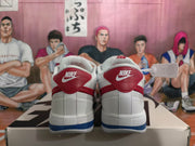 Rear view of white Nike sneakers with red heel panels and blue outsole detailing.