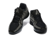 Pair of black Nike low-top sneakers shown from the front, with silver rhinestone-style detailing and contrasting tongue logos.