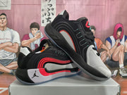 Angled view showing the black, white, and red Jordan basketball sneaker design with layered side panels.