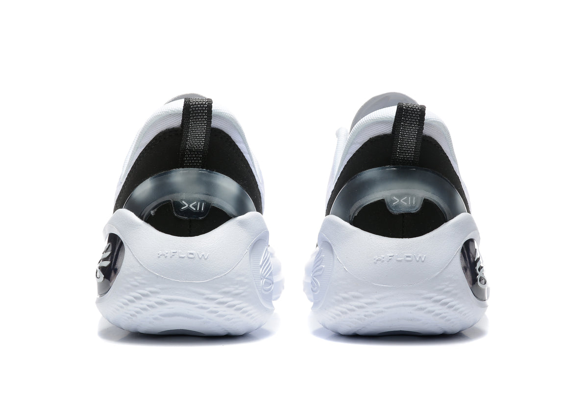 Rear view of white and black basketball sneakers showing black heel panels, pull tabs, and sculpted white soles.