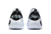 Rear view of white and black basketball sneakers showing black heel panels, pull tabs, and sculpted white soles.
