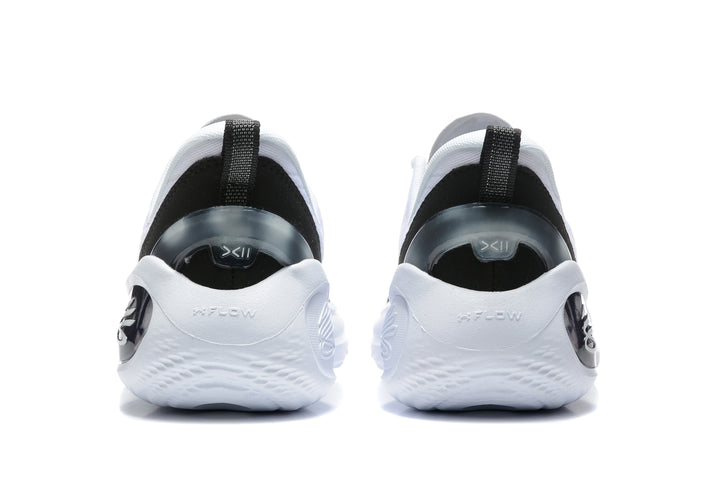 Rear view of white and black basketball sneakers showing black heel panels, pull tabs, and sculpted white soles.