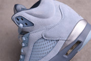 Close-up side view showing the perforated mesh panel, icy blue overlay, silver accent, and visible midsole window.