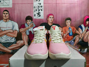 Front view of pink Nike basketball sneakers with off-white laces, collars, and multicolored tongue details.
