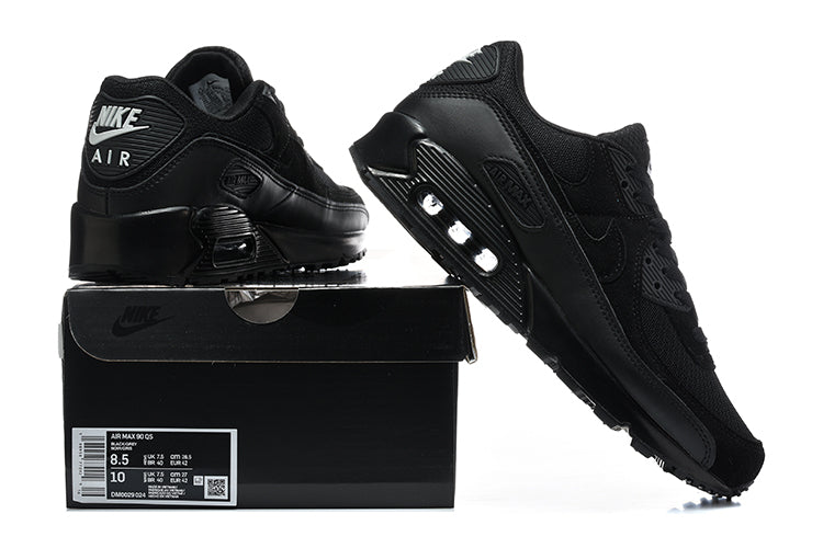 Black Nike Air Max 90 QS sneakers displayed with a black shoe box; the box label shows a sample size.