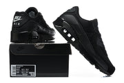 Black Nike Air Max 90 QS sneakers displayed with a black shoe box; the box label shows a sample size.