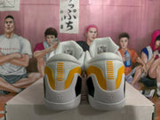 Rear view showing yellow heel panels, white collars, black side inserts, and basketball-style heel logos.