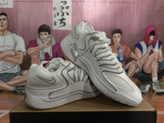 Angled view of white Nike sneakers showing the layered upper panels, Swoosh branding, and gray-accented sole.