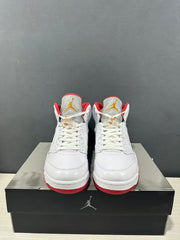 Front view of the pair showing white uppers, red lining and gold-colored tongue logos.