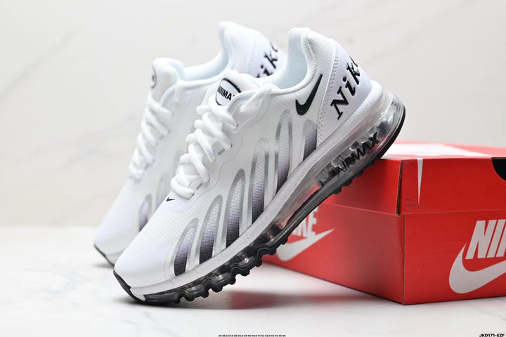 White and black Nike sneakers with a visible cushioned-style sole, shown beside a red shoe box.