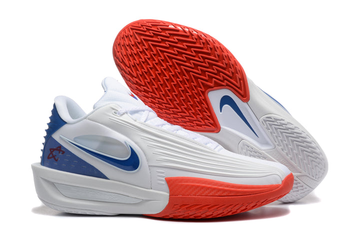 White Nike basketball shoes with blue details and bright red patterned outsoles