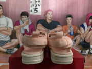 Rear view of the pink sandals showing the heel pull tabs, back straps and light-colored soles.