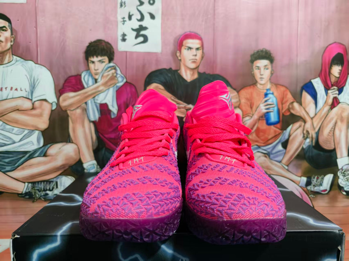 Pair of pink and purple Nike basketball shoes shown from the front.