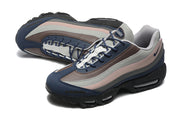 Angled pair view showing the layered color panels, navy laces, and black soles