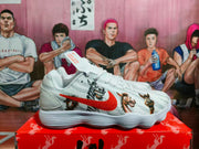 Side view of a white Nike sneaker with a red Swoosh and colorful anime-style character graphics.