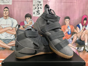 Angled view highlighting the high-top construction, multiple straps, lace closure, and textured outsole.