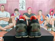 Rear view of the pair showing padded black collars, translucent olive heel structures, and red signature-style graphics.