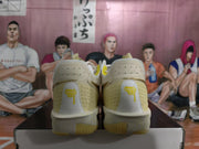 Rear view of white Nike basketball sneakers showing yellow heel details and translucent outsole sections