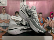 Angled view of the Nike sneakers highlighting the patterned upper, side branding, sculpted midsole, and outsole.