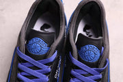 Close-up of the sneakers’ blue Air Jordan tongue badges, purple laces, and padded black collars.