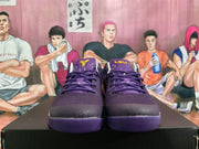 Front view of purple lace-up basketball shoes with yellow tongue details