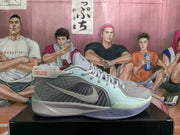 Side profile of a sky blue and grey Nike basketball sneaker showing the Swoosh, layered upper panels, padded collar, and contrasting outsole.