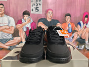 Front view of black Nike Book 1 sneakers with black laces, perforated toe panels, and a visible hangtag.
