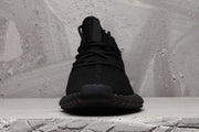 Front view showing the tongue, black laces, rounded toe, and dark outsole.