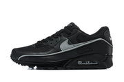 Side profile of a black Nike Air Max 90 sneaker with a silver Swoosh and visible Air unit.