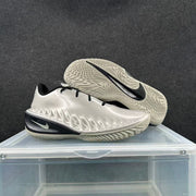 Pair of metallic silver sneakers showing the sculpted uppers, black accents, white Swoosh details, and textured outsoles.