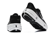Rear and outsole views of black Nike Comfort Ride EasyOn sneakers with thick white midsoles.