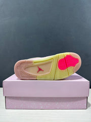 Outsole view showing the textured tread, pink traction sections, pale yellow sections, and Jordan logo.