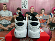 Rear view showing the pair's padded collars, heel branding, and white-and-black color blocking.
