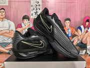 Angled view of two black Nike basketball sneakers displaying the side branding, ribbed toe design, and textured outsoles.