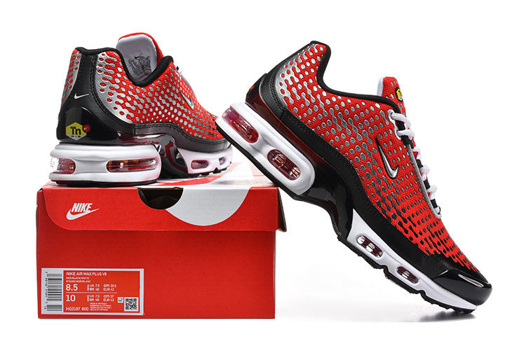 Red and black Nike Air Max Plus sneakers displayed with a box showing the sample size label